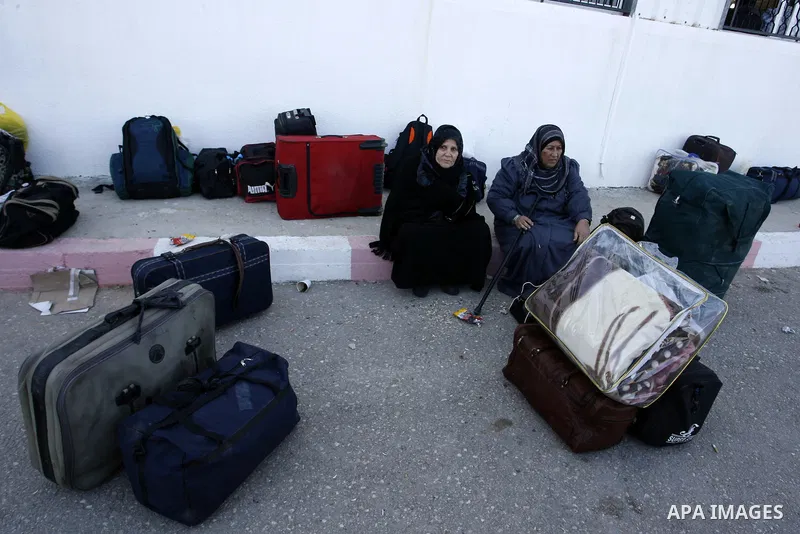 Palestinians wait to cross the Rafah border crossing in the southern Gaza Strip into Egypt on Feb. 22, 2012. Maher Abu Sabha, Director General of the crossings in the Gaza government resign from office an Interior Minist...