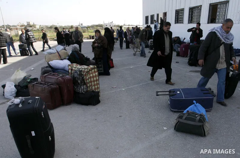 Palestinians wait to cross the Rafah border crossing in the southern Gaza Strip into Egypt on Feb. 22, 2012. Maher Abu Sabha, Director General of the crossings in the Gaza government resign from office an Interior Minist...