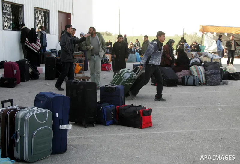 Palestinians wait to cross the Rafah border crossing in the southern Gaza Strip into Egypt on Feb. 22, 2012. Maher Abu Sabha, Director General of the crossings in the Gaza government resign from office an Interior Minist...