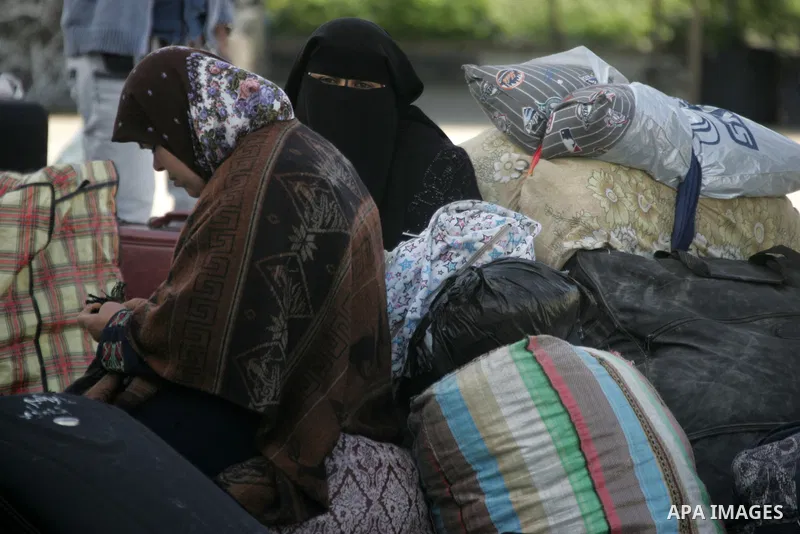 Palestinians wait to cross the Rafah border crossing in the southern Gaza Strip into Egypt on Feb. 22, 2012. Maher Abu Sabha, Director General of the crossings in the Gaza government resign from office an Interior Minist...