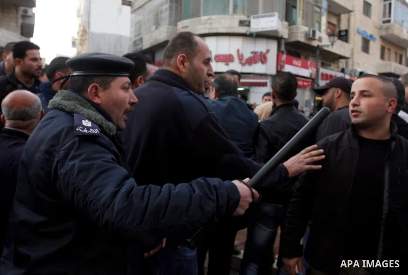 Dozens of Palestinian supporters of Syrian President Bashar al-Assad's clash with dozens of people against the Assad regime in the West Bank city of Ramallah, on February 22, 2012, forcing the police to intervene to sepa...