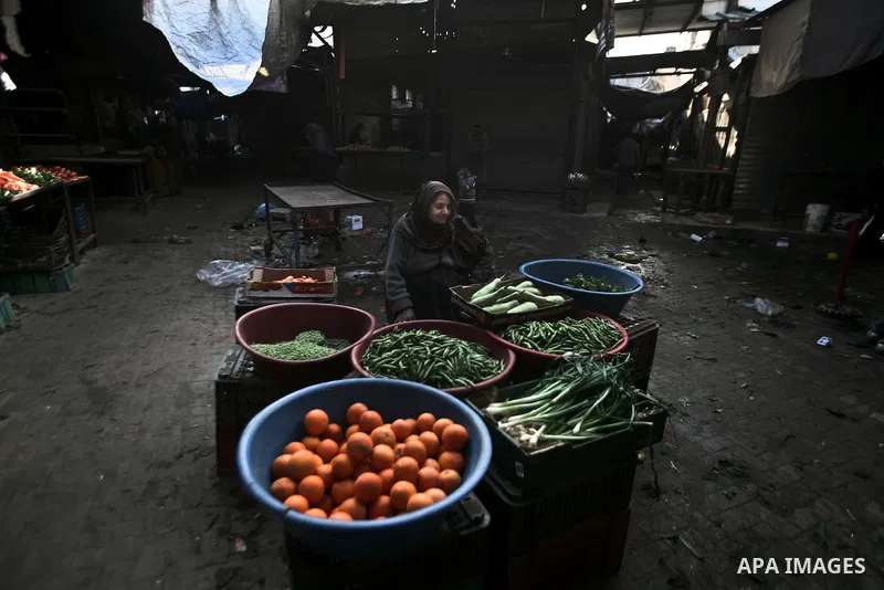 A Palestinian woman sells vegetables on a market in the Jabaliya refugee camp, northern Gaza Strip, 22 February 2012. The United Nations Relief and Works Agency (UNRWA) states that the Israeli blockade on Gaza has made l...