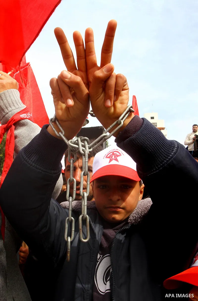 Supporters of the Democratic Front for the Liberation of Palestine (DFLP) shout slogans during a rally marking the 43rd anniversary of the movement's establishment in Gaza City on February 23, 2012. Photo by Ashraf Amra