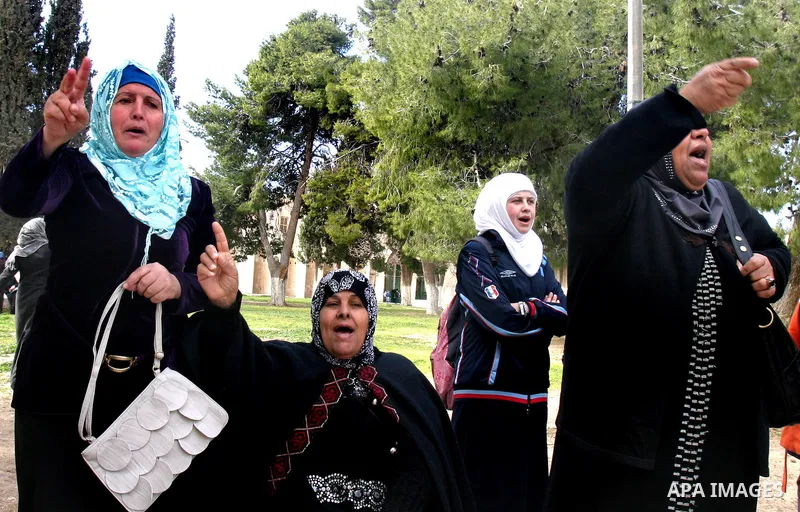 Palestinian women protest, while Jewish settlers entered the Al-Aqsa mosque compound in Jerusalem’s Old City on February 23, 2012.A Palestinian resident of Jerusalem's Old City who was at the site during the incident, to...