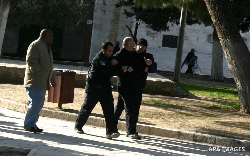 Israeli border policemen scuffle with a Palestinian man, while Jewish settlers entered the Al-Aqsa mosque compound in Jerusalem’s Old City on February 23, 2012.A Palestinian resident of Jerusalem's Old City who was at th...