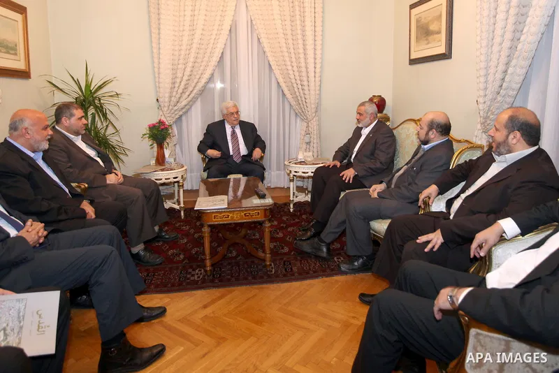 Palestinian President Mahmud Abbas meets with Palestinian prime minister in Gaza Strip, Ismail Haniya in Cairo on February 23,2012, to implement the terms of a reconciliation deal they signed in the Egyptian capital in M...