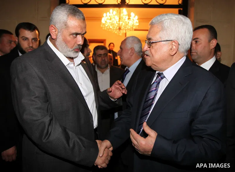 Palestinian President Mahmud Abbas meets with Palestinian prime minister in Gaza Strip, Ismail Haniya in Cairo on February 23,2012, to implement the terms of a reconciliation deal they signed in the Egyptian capital in M...