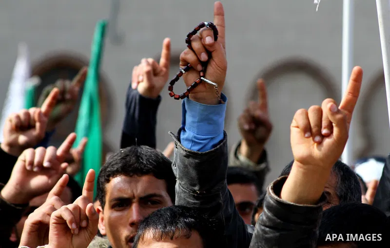Palestinian protesters shout slogans as they gather in Khan Yunis in the southern Gaza Strip on February 24, 2012 during a demonstration to show solidarity for Jerusalem's Al-Aqsa mosque compound. Clashes briefly broke o...