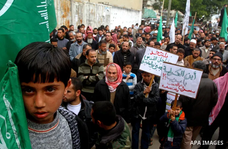 Palestinian protesters shout slogans as they gather in Khan Yunis in the southern Gaza Strip on February 24, 2012 during a demonstration to show solidarity for Jerusalem's Al-Aqsa mosque compound. Clashes briefly broke o...