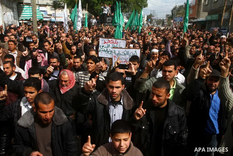 Palestinian protesters shout slogans as they gather in Khan Yunis in the southern Gaza Strip on February 24, 2012 during a demonstration to show solidarity for Jerusalem's Al-Aqsa mosque compound. Clashes briefly broke o...
