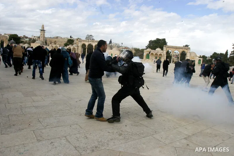 Israeli riot police clashing with Palestinians as the police hurl stun grenades and rocks are seen flying on the plaza next to the Dome of the Rockduring clashes with Palestinian protesters on the compound known to Musli...
