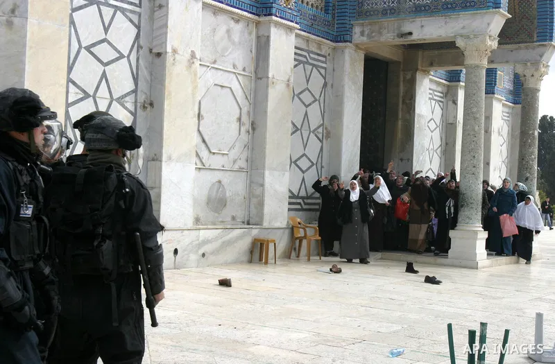 Palestinian women gesture as they shout at Israeli policemen during clashes with Palestinian protesters on the compound known to Muslims as the Noble Sanctuary and to Jews as the Temple Mount in Jerusalem's Old City Febr...