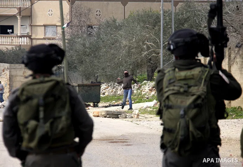 Palestinian protesters clash with Israeli soldiers during a demonstration against the expropriation of Palestinian land by Israel in the village of Kfar Qaddum, near the West Bank city of Nablus, on February 24, 2012. Ph...