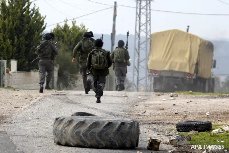 Palestinian protesters clash with Israeli soldiers during a demonstration against the expropriation of Palestinian land by Israel in the village of Kfar Qaddum, near the West Bank city of Nablus, on February 24, 2012. Ph...