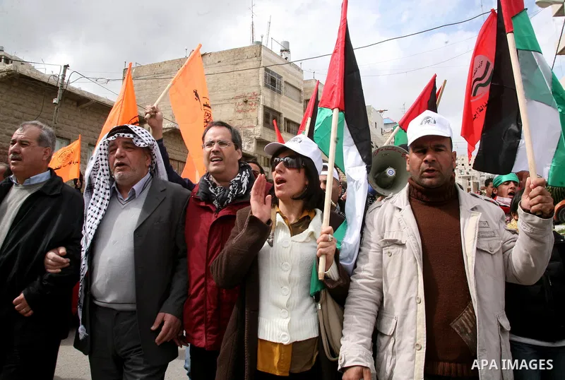 Palestinian demonstrators, joined by Israeli and foreign peace activists, shout slogans during a demonstration against the closure of Shuhada street to Palestinians, in the West Bank city of Hebron February 24, 2012. Som...