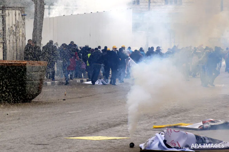 An Israeli policeman fires a tear gas canister during clashes with Palestinian protesters at a demonstration against the closure of Shuhada street to Palestinians, in the West Bank city of Hebron February 24, 2012. Some...