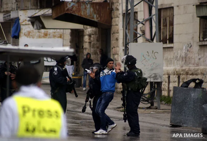 Israeli policemen arrest a protester during clashes with Palestinian protesters at a demonstration against the closure of Shuhada street to Palestinians, in the West Bank city of Hebron February 24, 2012. Some 200 protes...