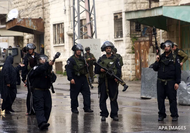 Israeli policemen stand guards during clashes with Palestinian protesters at a demonstration against the closure of Shuhada street to Palestinians, in the West Bank city of Hebron February 24, 2012. Some 200 protesters,...