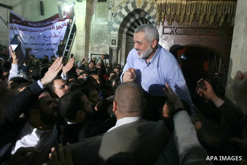 Palestinian prime minister in Gaza Strip, Ismail Haniya greets supporters as he leaves following Friday noon prayer at Al-Azhar mosque, in Cairo, Egypt, 24 February 2012. According to media reports, Haniyeh joined hundre...