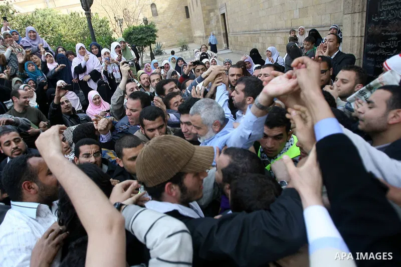 Palestinian prime minister in Gaza Strip, Ismail Haniya greets supporters as he leaves following Friday noon prayer at Al-Azhar mosque, in Cairo, Egypt, 24 February 2012. According to media reports, Haniyeh joined hundre...