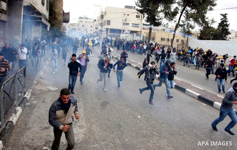 Palestinians protesters clash with Israeli soldiers during a demonstration commemorating 18 years to the Hebron massacre and calling to open Shuhada street in the West Bank city of Hebron, Friday, Feb. 24, 2012. In 1994,...