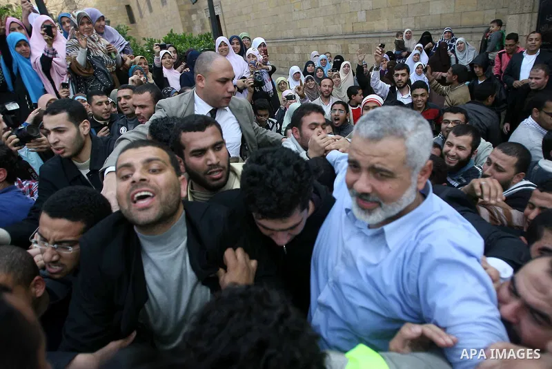 Palestinian prime minister in Gaza Strip, Ismail Haniya greets supporters as he leaves following Friday noon prayer at Al-Azhar mosque, in Cairo, Egypt, 24 February 2012. According to media reports, Haniyeh joined hundre...