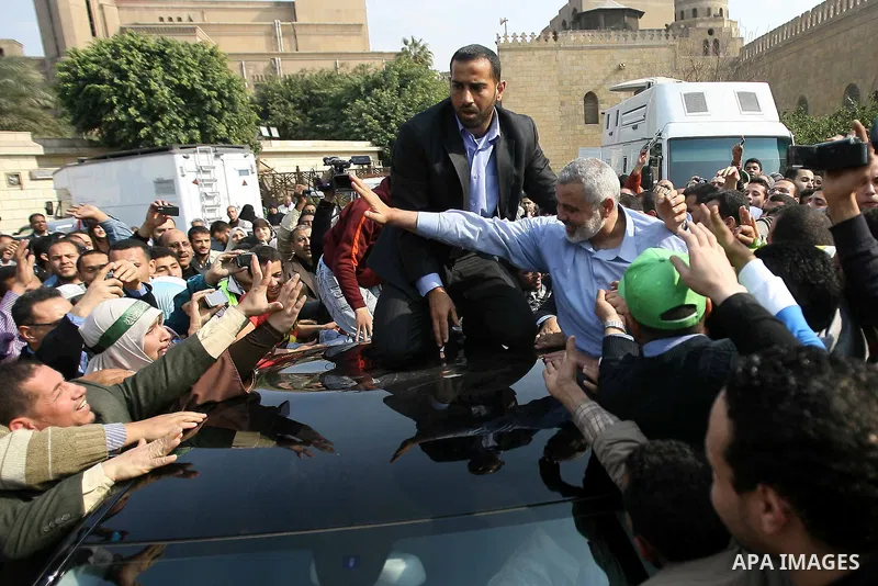 Palestinian prime minister in Gaza Strip, Ismail Haniya greets supporters as he leaves following Friday noon prayer at Al-Azhar mosque, in Cairo, Egypt, 24 February 2012. According to media reports, Haniyeh joined hundre...