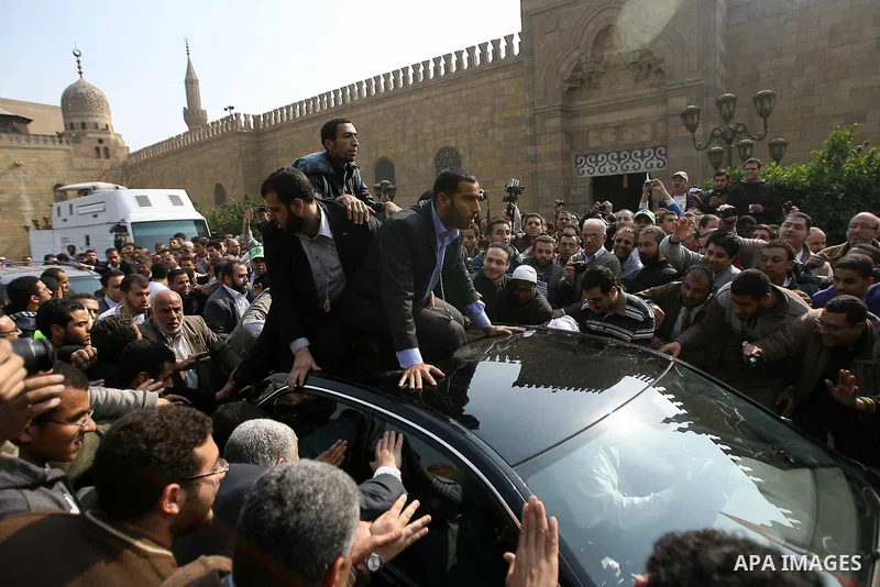 Palestinian prime minister in Gaza Strip, Ismail Haniya (inside car) greets supporters as he leaves following Friday noon prayer at Al-Azhar mosque, in Cairo, Egypt, 24 February 2012. According to media reports, Haniyeh...