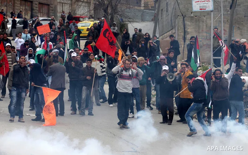 Palestinians protesters clash with Israeli soldiers during a demonstration commemorating 18 years to the Hebron massacre and calling to open Shuhada street in the West Bank city of Hebron, Friday, Feb. 24, 2012. In 1994,...