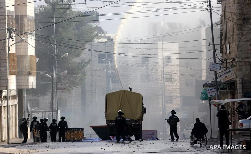 Palestinians protesters clash with Israeli soldiers during a demonstration commemorating 18 years to the Hebron massacre and calling to open Shuhada street in the West Bank city of Hebron, Friday, Feb. 24, 2012. In 1994,...