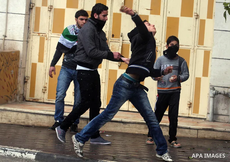 Palestinians protesters clash with Israeli soldiers during a demonstration commemorating 18 years to the Hebron massacre and calling to open Shuhada street in the West Bank city of Hebron, Friday, Feb. 24, 2012. In 1994,...