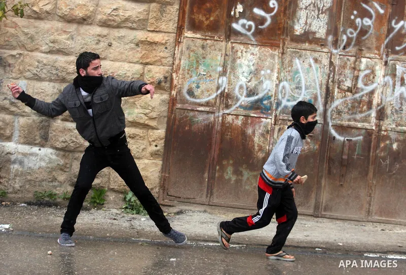 Palestinians protesters clash with Israeli soldiers during a demonstration commemorating 18 years to the Hebron massacre and calling to open Shuhada street in the West Bank city of Hebron, Friday, Feb. 24, 2012. In 1994,...