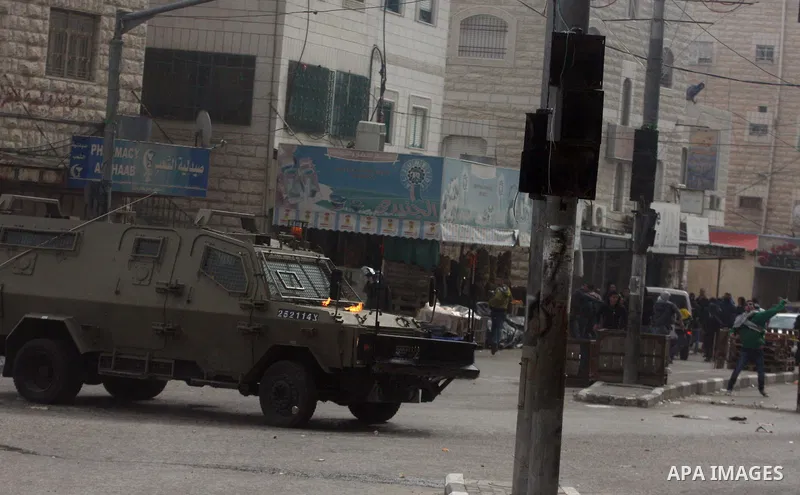 Palestinians protesters clash with Israeli soldiers during a demonstration commemorating 18 years to the Hebron massacre and calling to open Shuhada street in the West Bank city of Hebron, Friday, Feb. 24, 2012. In 1994,...