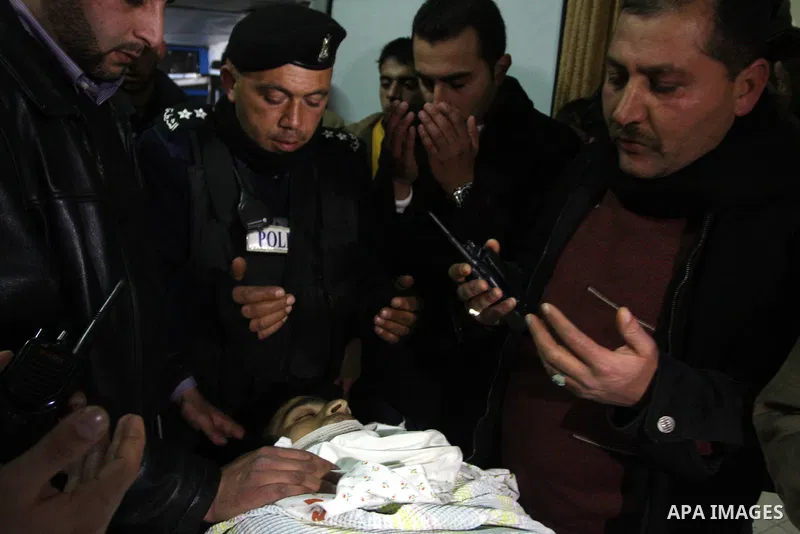 Palestinians relatives mourn over the body of Talat Ramya "25", killed by Israeli military, during clashes following a weekly demonstration at the West bank refugee camp of Qalandia, near Ramallah, on Feb. 24. 2012. Phot...