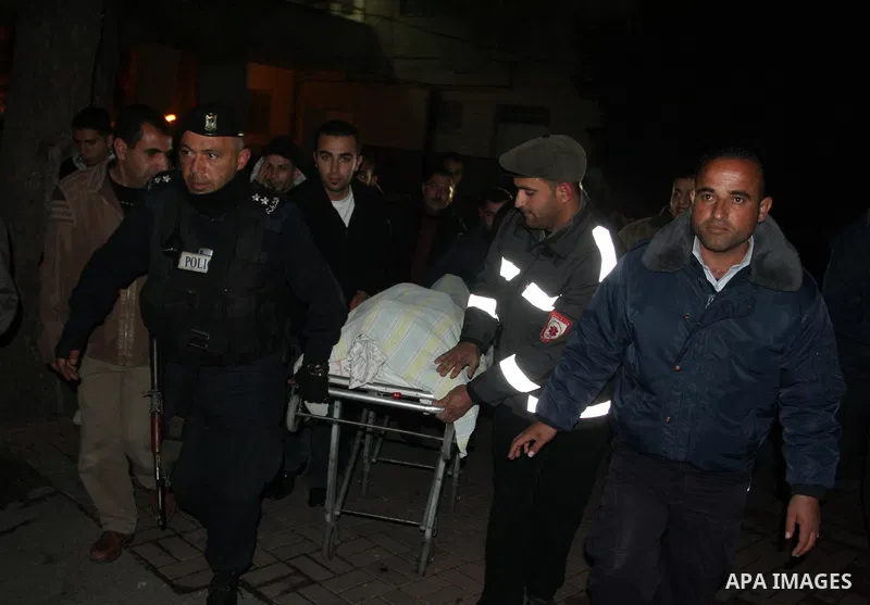 Palestinians relatives mourn over the body of Talat Ramya "25", killed by Israeli military, during clashes following a weekly demonstration at the West bank refugee camp of Qalandia, near Ramallah, on Feb. 24. 2012. Phot...