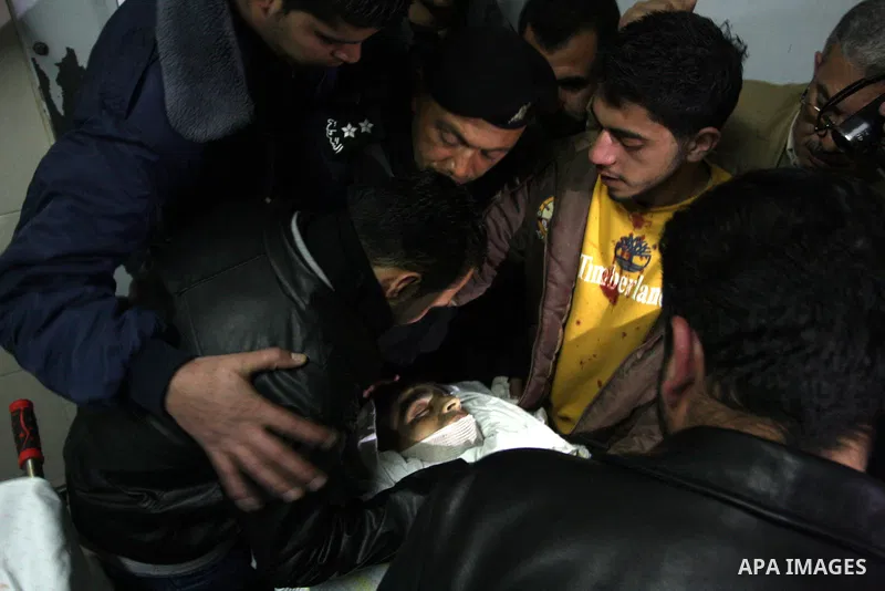 Palestinians relatives mourn over the body of Talat Ramya "25", killed by Israeli military, during clashes following a weekly demonstration at the West bank refugee camp of Qalandia, near Ramallah, on Feb. 24. 2012. Phot...