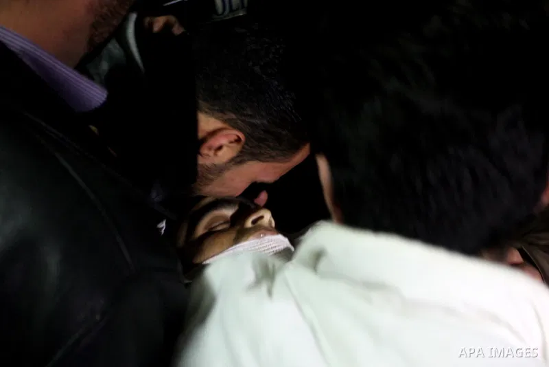Palestinians relatives mourn over the body of Talat Ramya "25", killed by Israeli military, during clashes following a weekly demonstration at the West bank refugee camp of Qalandia, near Ramallah, on Feb. 24. 2012. Phot...