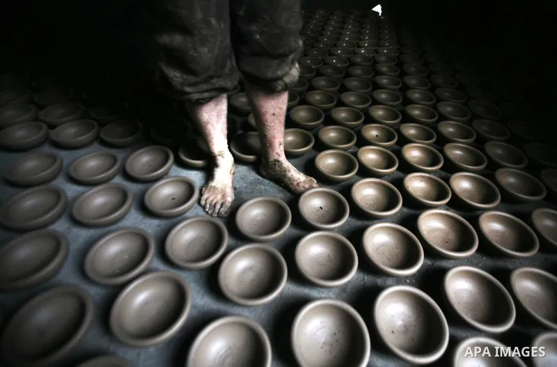 Palestinian Sabri Atallah, stores pots built with natural clay at his grandfather's shop 'Atallah Pottery', in Gaza Strip on 23 February 2012. Atallah pottery shop is one of the biggest pottery shops in Gaza strip. Child...