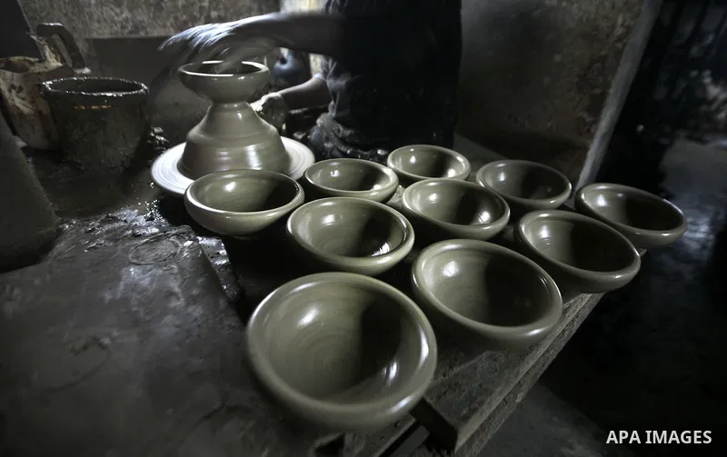 Palestinian Ayman Atallah, stores pots built with natural clay at his grandfather's shop 'Atallah Pottery', in Gaza Strip on 23 February 2012. Atallah pottery shop is one of the biggest pottery shops in Gaza strip. Child...
