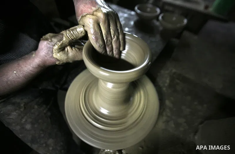 Palestinian Ayman Atallah, stores pots built with natural clay at his grandfather's shop 'Atallah Pottery', in Gaza Strip on 23 February 2012. Atallah pottery shop is one of the biggest pottery shops in Gaza strip. Child...