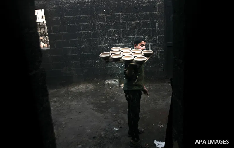 Palestinian Sabri Atallah, stores pots built with natural clay at his grandfather's shop 'Atallah Pottery', in Gaza Strip on 24 February 2012. Atallah pottery shop is one of the biggest pottery shops in Gaza strip. Child...