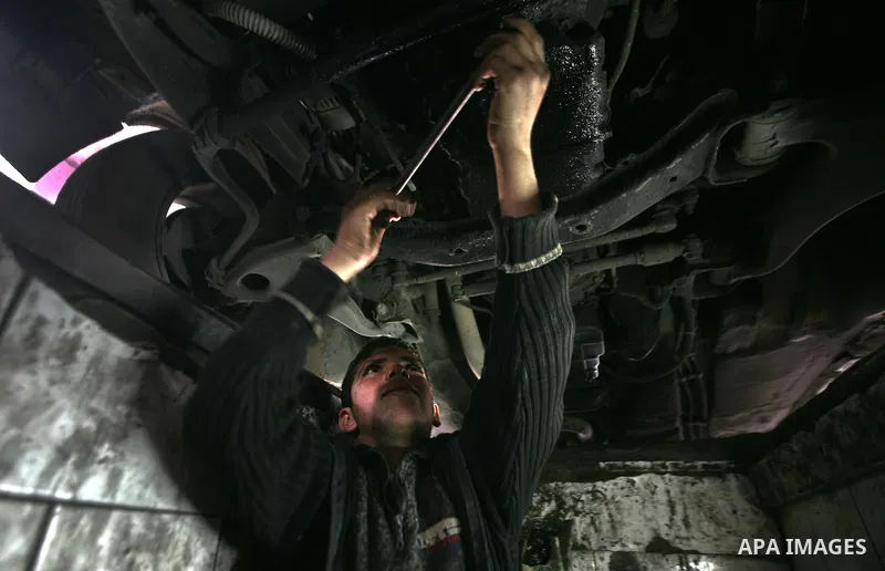 Palestinian children work repairing a car tyre in the town of Beit Lahyia in northern Gaza on 23 February 2012. Reports state that child labor is widespread in the Gaza Strip because of the high rate of poverty and unemp...