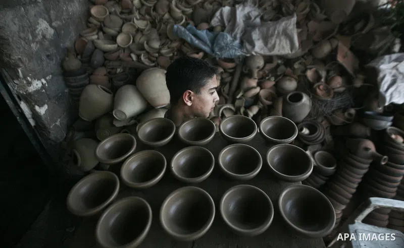 Palestinian Sabri Atallah, stores pots built with natural clay at his grandfather's shop 'Atallah Pottery', in Gaza Strip on 24 February 2012. Atallah pottery shop is one of the biggest pottery shops in Gaza strip. Child...