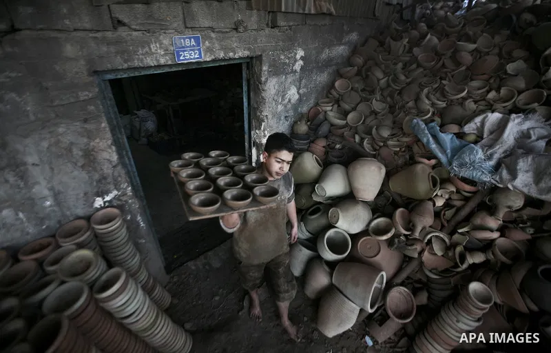 Palestinian Sabri Atallah, stores pots built with natural clay at his grandfather's shop 'Atallah Pottery', in Gaza Strip on 24 February 2012. Atallah pottery shop is one of the biggest pottery shops in Gaza strip. Child...