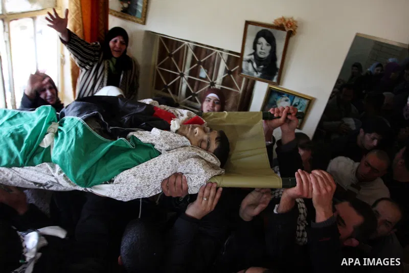 Palestinian women mourn the death of Talaat Rameya during his funeral procession in the town of Al-Ram on the outskirts of Jerusalem on February 25, 2012. Rameya was killed in one of a string of clashes on February 24 be...