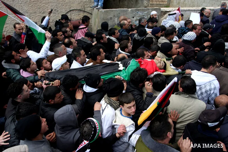 Palestinians carry the body of 23-year-old Talat Ramia during his funeral in the West Bank town of Al-Ram, near Jerusalem February 25, 2012. Ramia, a Palestinian protester who participated in clashes against Israeli sold...