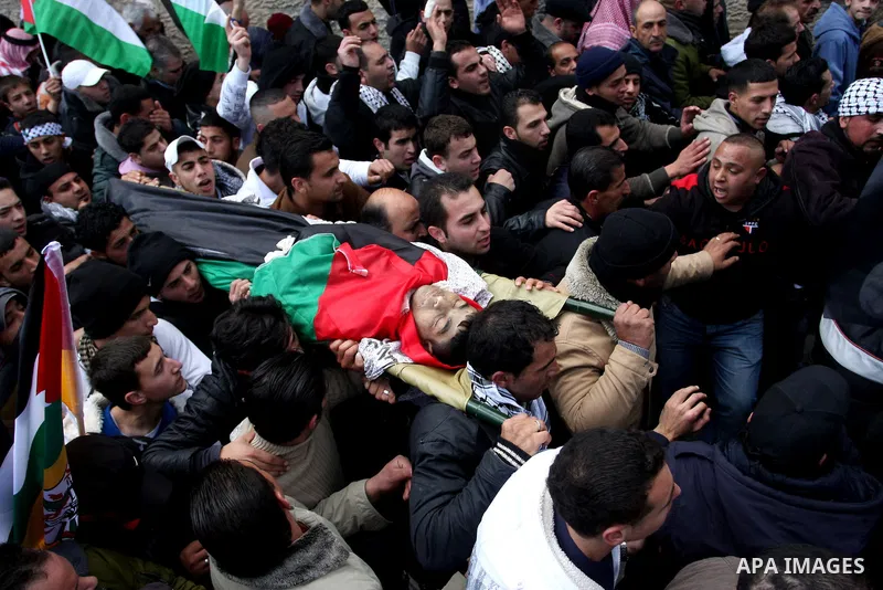 Palestinians carry the body of 23-year-old Talat Ramia during his funeral in the West Bank town of Al-Ram, near Jerusalem February 25, 2012. Ramia, a Palestinian protester who participated in clashes against Israeli sold...