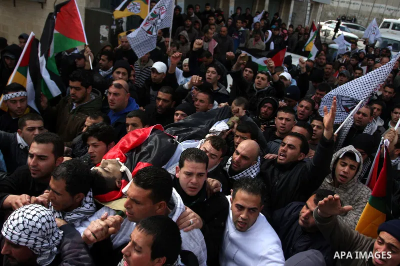 Palestinians carry the body of 23-year-old Talat Ramia during his funeral in the West Bank town of Al-Ram, near Jerusalem February 25, 2012. Ramia, a Palestinian protester who participated in clashes against Israeli sold...