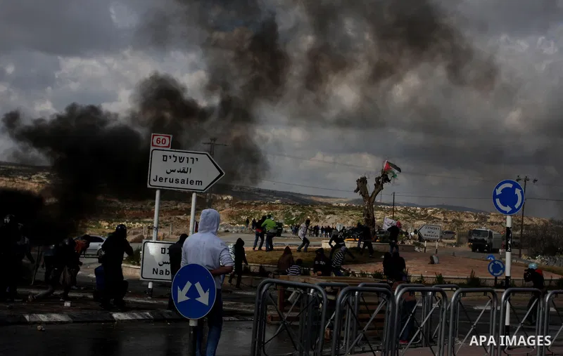 Tires burn as Palestinians clash with Israeli troops in the West Bank neighbourhood of Al-Ram, adjacent to Israeli-annexed east Jerusalem, on February 25, 2012. At least nine Palestinians were injured in the clashes foll...