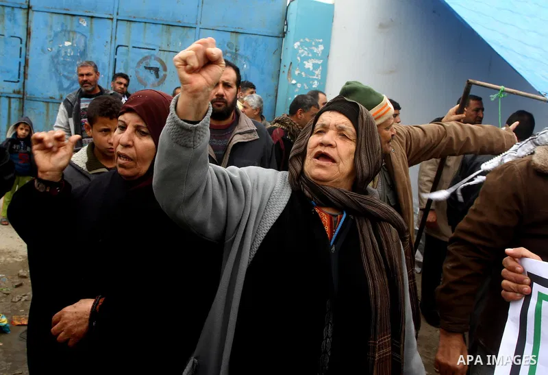 Palestinians take part in a protest in front of the UNRWA headquarters, against reducing the services provided to Palestine refugees in Gaza city, on Feb. 26, 2012. Photo by Ashraf Amra